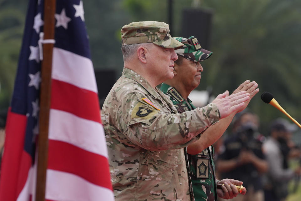 U.S. Chairman of the Joint Chiefs of Staff Gen. Mark Milley, left, and Indonesian Armed Forces Chief Gen. Andika Perkasa salute as they inspect honor guards during their meeting at Indonesian military headquarters in Jakarta, Indonesia, Sunday, July 24, 2022. (AP Photo/Achmad Ibrahim)