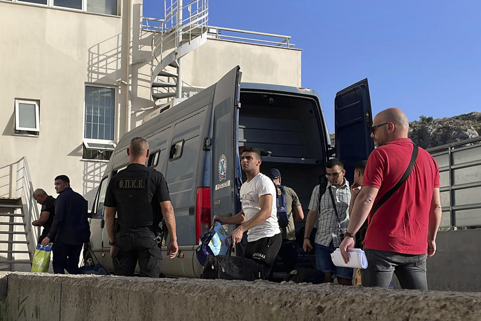 Egyptian shipwreck survivors enter a police station to be processed following their release from prison, in the town of Nafplio, about 136 kilometers (85 miles) southwest of Athens, Greece, Wednesday, May 22, 2024. A Greek court Monday dismissed a case against nine Egyptian defendants accused of causing a shipwreck off the southern coast of Greece last June that killed several hundred migrants travelling from Libya to Italy. The suspects had spent 11 months in pre-trial prison detention. (AP Photo/Derek Gatopoulos)