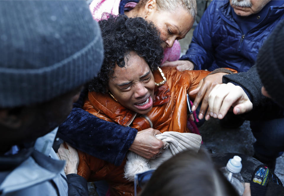 Protesters help Yandy Smith after she received pepper spray following she and others stormed the main entrance to the Metropolitan Detention Center, a federal facility where prisoners have gone without heat, hot water and flushing toilets due to an electrical outage, Sunday, Feb. 3, 2019, in New York. (AP Photo/Kathy Willens)