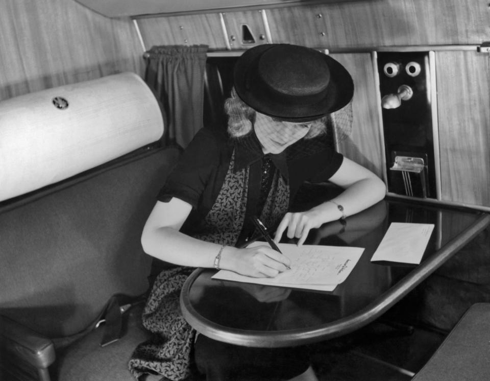 A young woman writes a letter during an American Airlines flight, circa 1935.&nbsp;