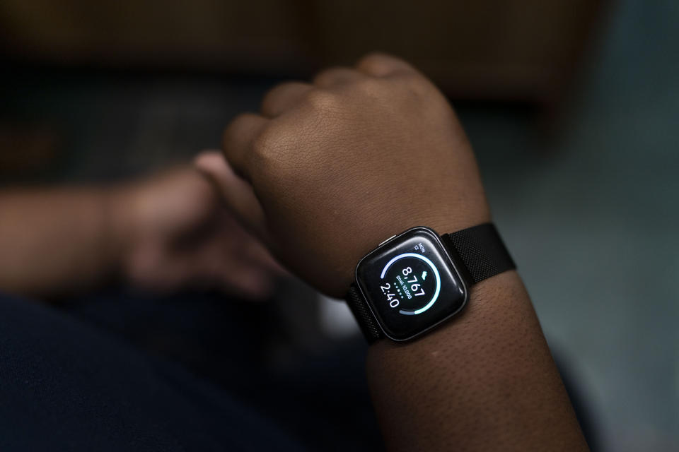 John Simon, a teenager who had a bariatric surgery in 2022, shows his smartwatch displaying daily steps in Los Angeles, Monday, March 13, 2023. (AP Photo/Jae C. Hong)