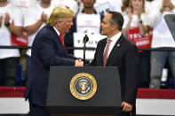 President Donald Trump, left, shakes hands with Kentucky Gov. Matt Bevin during a campaign rally in Lexington, Ky., Monday, Nov. 4, 2019. (AP Photo/Timothy D. Easley)