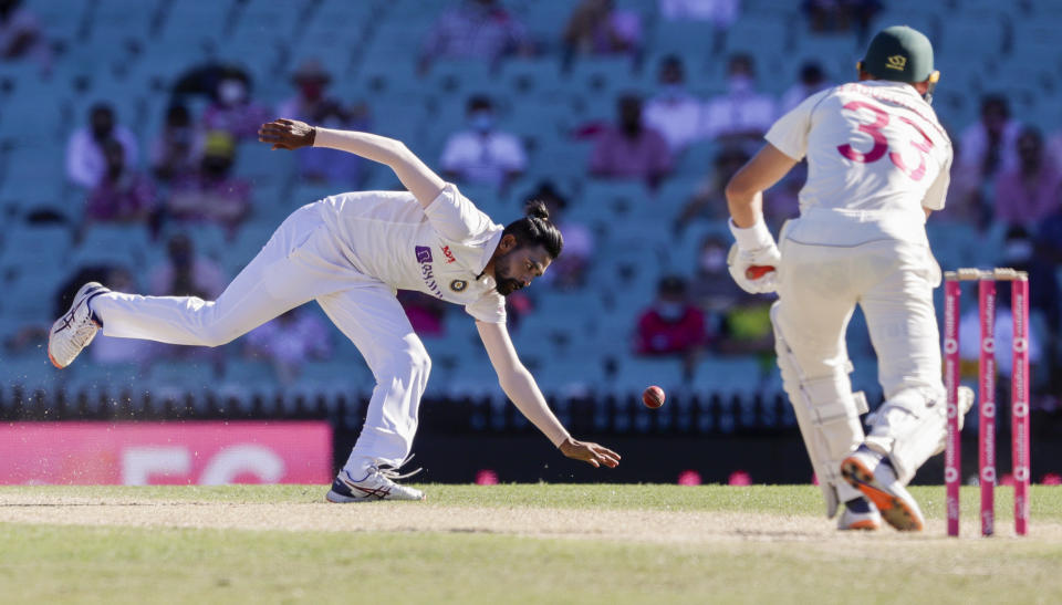 India's Mohammed Siraj reaches down to field the ball hit by Australia's Marnus Labuschagne, right, during play on day three of the third cricket test between India and Australia at the Sydney Cricket Ground, Sydney, Australia, Saturday, Jan. 9, 2021. (AP Photo/Rick Rycroft)