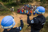 FILE PHOTO - Members of the Chinese Formed Police Unit (FPU) deployed at UN Mission in Liberia (UNMIL) greet children during a long-range patrol to Tubmanburg, Liberia February 1, 2018. Albert Gonzalez Farran/UNMIL/Handout via REUTERS