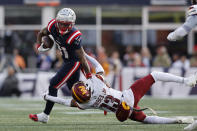 New England Patriots wide receiver Demario Douglas, left, tries to elude Washington Commanders cornerback Emmanuel Forbes, right, in the second half of an NFL football game, Sunday, Nov. 5, 2023, in Foxborough, Mass. (AP Photo/Michael Dwyer)