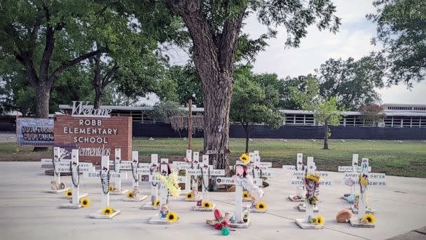 PHOTO: Crosses outside Robb Elementary School in Uvalde, Texas, are seen on May 7, 2023, with tributes to the 21 lives lost at the school. (ABC News)