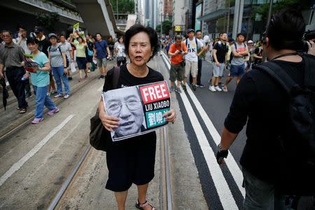 An activist holds a placard demanding the release of Chinese Nobel Peace Laureate Liu Xiaobo during a demonstration on the 20th anniversary of the territory's handover from Britain to Chinese rule, in Hong Kong, China July 1, 2017. REUTERS/Damir Sagolj