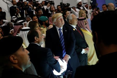 U.S. President Donald Trump and other leaders including Egypt's President Abdel Fattah al-Sisi (bottom, 2nd L) and Malaysia's Prime Minister Najib Razak (4th R) react to a wall of computer screens coming online as they tour the Global Center for Combatting Extremist Ideology in Riyadh, Saudi Arabia May 21, 2017. REUTERS/Jonathan Ernst