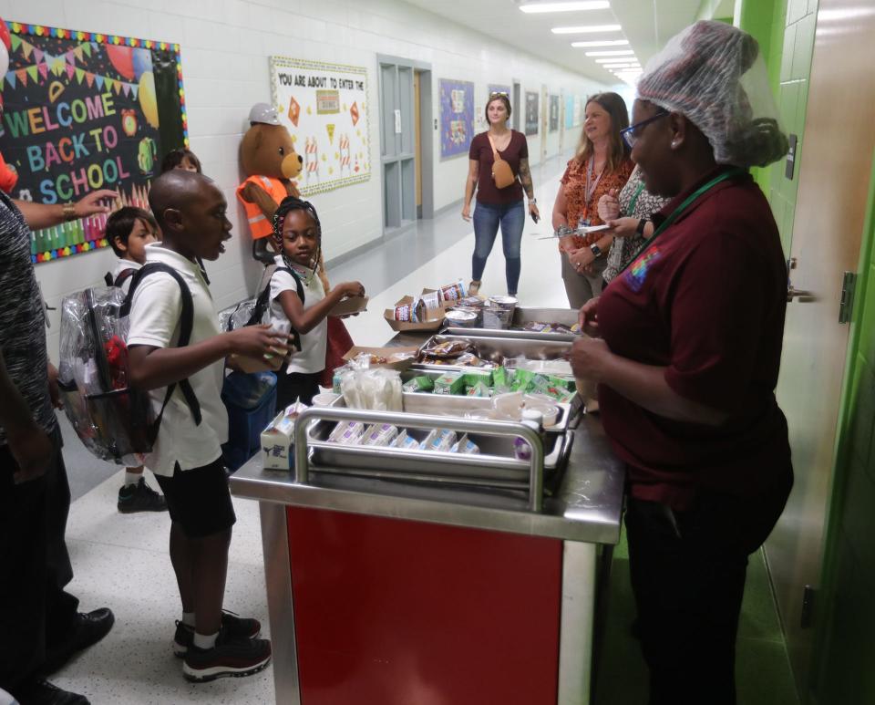 Bloomingdale Elementary students grab a breakfast on their way to class after arriving at New Hampstead K-8 for the first day of school on Thursday, August 3, 2023.