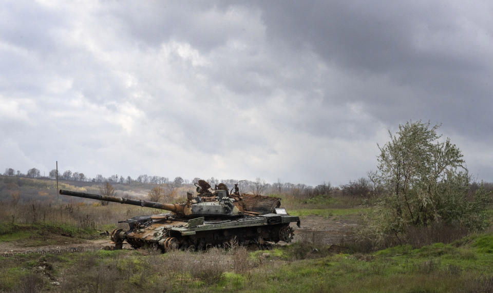 A Russian tank damaged in recent fighting is seen in the field near the recently retaken village of Kamianka, Kharkiv region, Ukraine, Sunday, Oct. 30, 2022. (AP Photo/Efrem Lukatsk)