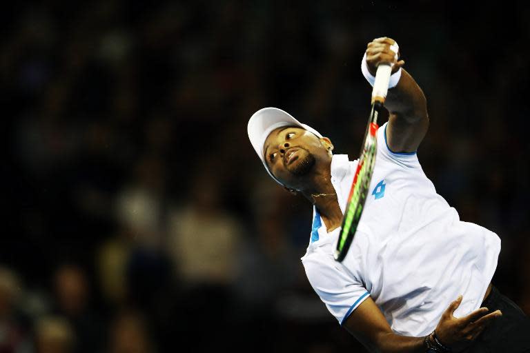 Donald Young plays a shot as he competes against Britain's Andy Murray during the first round of the Davis Cup tennis match Great Britain vs USA at the Emirates Arena in Glasgow on March 6, 2015