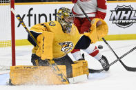 Nashville Predators goaltender Juuse Saros (74) blocks a Detroit Red Wings shot during the third period of an NHL hockey game Saturday, Jan. 22, 2022, in Nashville, Tenn. The Predators won 4-1. (AP Photo/Mark Zaleski)