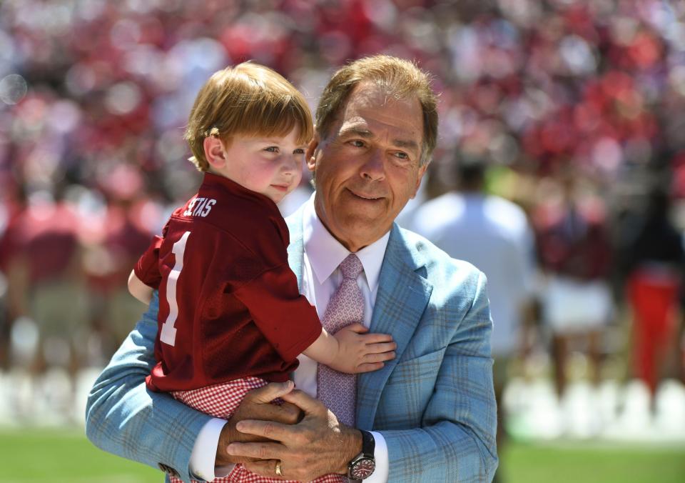 Alabama head coach Nick Saban holds his grandson before the A-Day game at Bryant-Denny Stadium on April 22, 2023.
