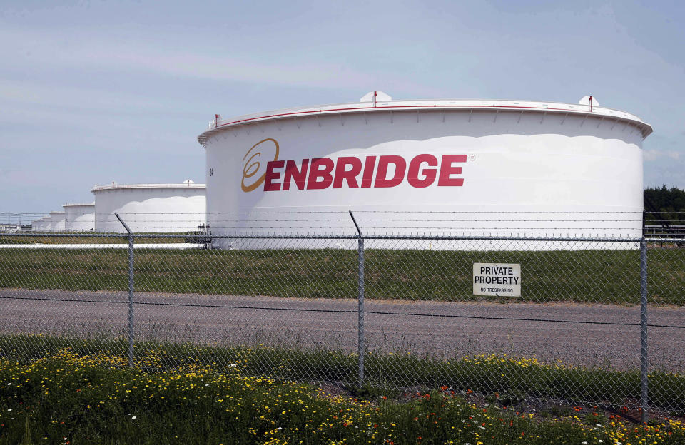 FILE - This June 29, 2018 photo shows tanks at the Enbridge Energy terminal in Superior, Wis. An updated environmental review released by a state agency Monday, Dec. 9, 2019, found no serious threat to Lake Superior if crude oil ever leaked from a new pipeline to replace Enbridge Energy's aging Line 3 across northern Minnesota. (AP Photo/Jim Mone, File)