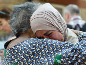 <p>Women comfort each other near the Grenfell apartment tower block in North Kensington, London, Britain, June 17, 2017. (Hannah McKay/Reuters) </p>