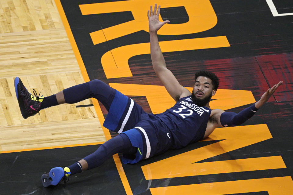 Minnesota Timberwolves center Karl-Anthony Towns reacts after a play where no foul was called during the first half of the team's NBA basketball game against the Orlando Magic, Sunday, May 9, 2021, in Orlando, Fla. (AP Photo/Phelan M. Ebenhack)