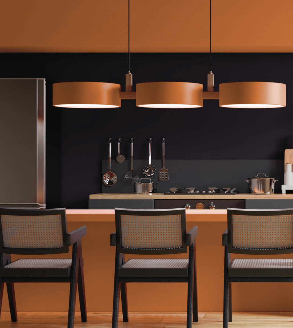 A kitchen painted in a smoky orange with dark backsplash