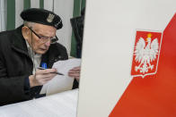 A man prepares his ballot for a parliamentary elections in Warsaw, Poland, Sunday, Oct. 15, 2023. Poland is holding an election Sunday that many see as its most important one since the 1989 vote that toppled communism. At stake are the health of the nation's democracy, its legal stance on LGBTQ+ rights and abortion, and the foreign alliances of a country on NATO's eastern flank that has been a crucial ally to Ukraine. (AP Photo/Czarek Sokolowski)
