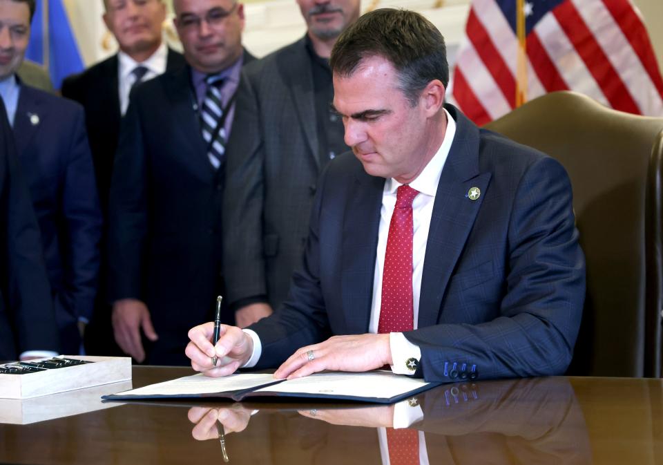 Oklahoma Gov. Kevin Stitt signs an executive order in the Blue Room at the state Capitol on Dec. 13. He issued a new executive order on Dec. 22, calling on a task force to study the effects of the McGirt v. Oklahoma ruling.