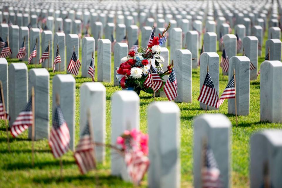 Thousands of tiny American flags decorate the graves of American service members at Biloxi National Cemetery in Biloxi ahead of Memorial Day on Saturday, May 25, 2024.