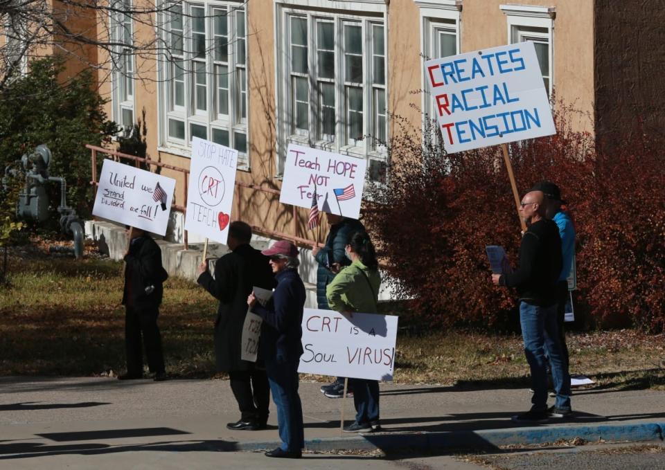 People protest outside the offices of the New Mexico Public Education Department’s office, on Nov. 12, 2021, in Albuquerque, New Mexico. As conservative-run states across the U.S. move to restrict discussion of race, gender, and identity in the classroom, progressive-run states are trying to prioritize those discussions. In New Mexico, education officials are moving forward with a social studies curriculum that increases focus on identity, race and “privilege or systemic inequity.” (AP Photo/Cedar Attanasio, File)