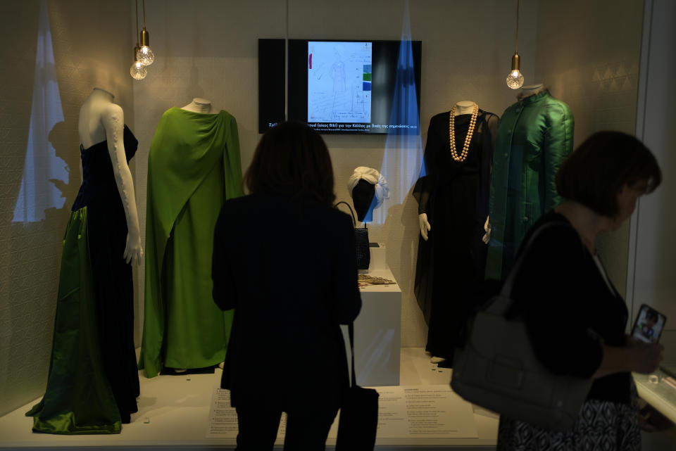 Two women look the dresses of Greek Soprano Maria Callas at the newly established Museum, the first dedicated to the legendary opera star, in Athens, Greece, Wednesday, Oct. 25, 2023. The new museum presents, priceless historical artifacts, including photographs and portraits, rare live recordings, and a unique collection of records and personal items as this year is the 100th anniversary of Maria Callas' birth. (AP Photo/Thanassis Stavrakis)