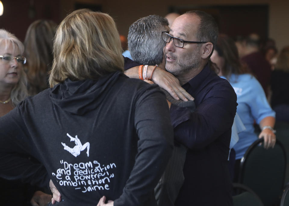 Fred Guttenberg, father of shooting victim Jaime Guttenberg and Max Schacter, the father of Alex hug during a break of the meeting of the Marjory Stoneman Douglas High School Public Safety Commission Thursday Nov 15, 2018, in Sunrise, Fla.)(Mike Stocker/South Florida Sun-Sentinel via AP, Pool