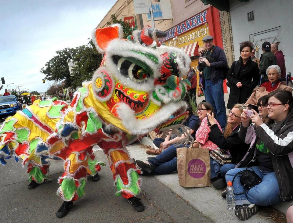 Lion dancers get up close and personal with spectators during the 14th annual Chinese New Year parade in Chinatown in this Fresno Bee file photo.