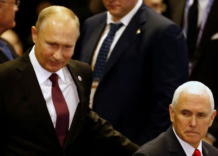 U.S. Vice President Mike Pence is greeted by Russia's President Vladimir Putin at the East Asia Summit in Singapore November 15, 2018. REUTERS/Edgar Su