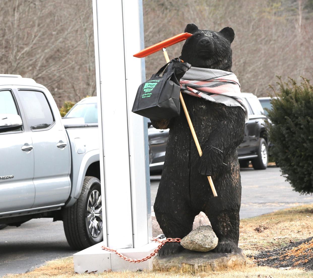 A not-so-real bear appears ready for the impending storm outside a Route 1 auto dealership in Portsmouth Friday, Jan. 28, 2022.