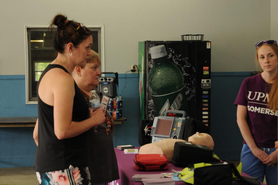 Melissa Friedline, of Acosta, left, and Kim Gardiner, of Somerset, spoke with Cassidy Beener-Terry at a Minutes Matter event and both wanted to be "more prepared" in case CPR may be needed.