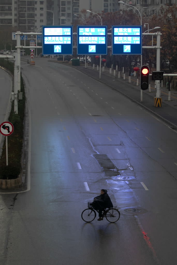 One major road was completely empty as a lone cyclist crosses. Source: Getty