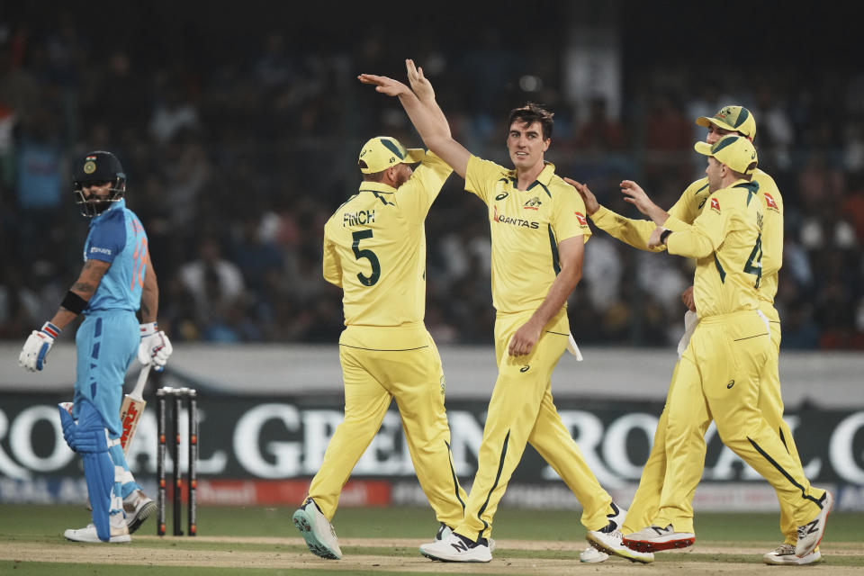 Australia's Pat Cummins, third right, celebrates with teammates the dismissal of India's captain Rohit Sharma during the third T20 cricket match between India and Australia, in Hyderabad, India, Sunday, Sept. 25, 2022. (AP Photo/Mahesh Kumar A)