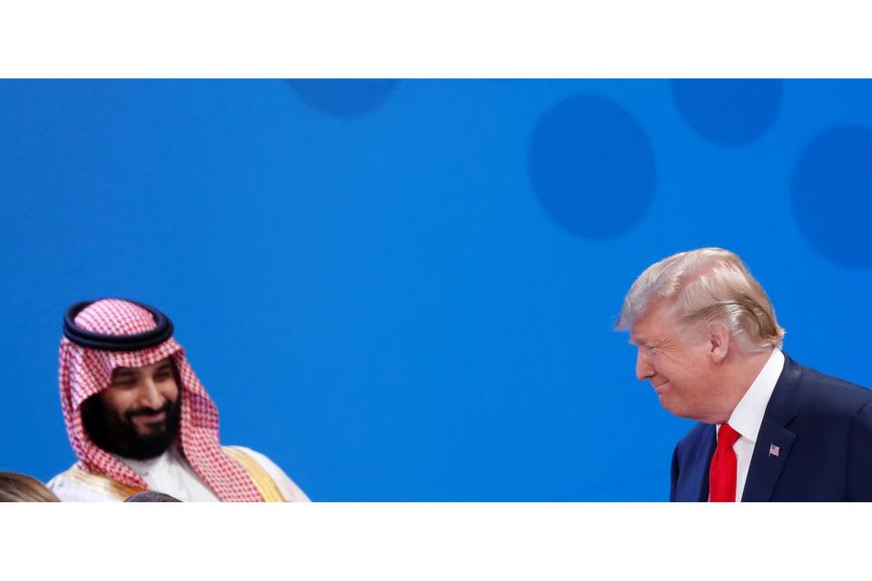 U.S. President Donald Trump walks past Saudi Crown Prince Mohammed bin Salman as he arrives for a family photo during the G20 leaders summit in Buenos Aires, Argentina November 30, 2018