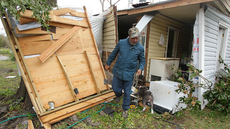 Semler Street resident Mack Robinson checks on his tornado-damaged home in 2012 in Prichard, Alabama.  - Mike Kittrell/AL.com/AP