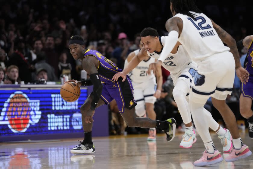 Los Angeles Lakers guard Dennis Schroder (17) controls the ball during the second half.