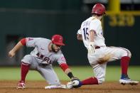 Los Angeles Angels second baseman David Fletcher (22) tags out Texas Rangers' Nick Solak (15) who was attempting to steal the bag in the third inning of a baseball game in Arlington, Texas, Tuesday, Sept. 28, 2021. (AP Photo/Tony Gutierrez)