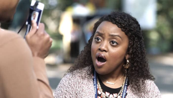 Quinta Brunson looks surprised while someone takes her photo with a digital camera outdoors