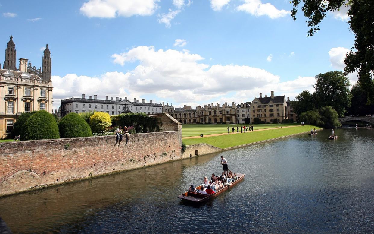 A punt on the river Cam passes Clare - Christopher Pledger