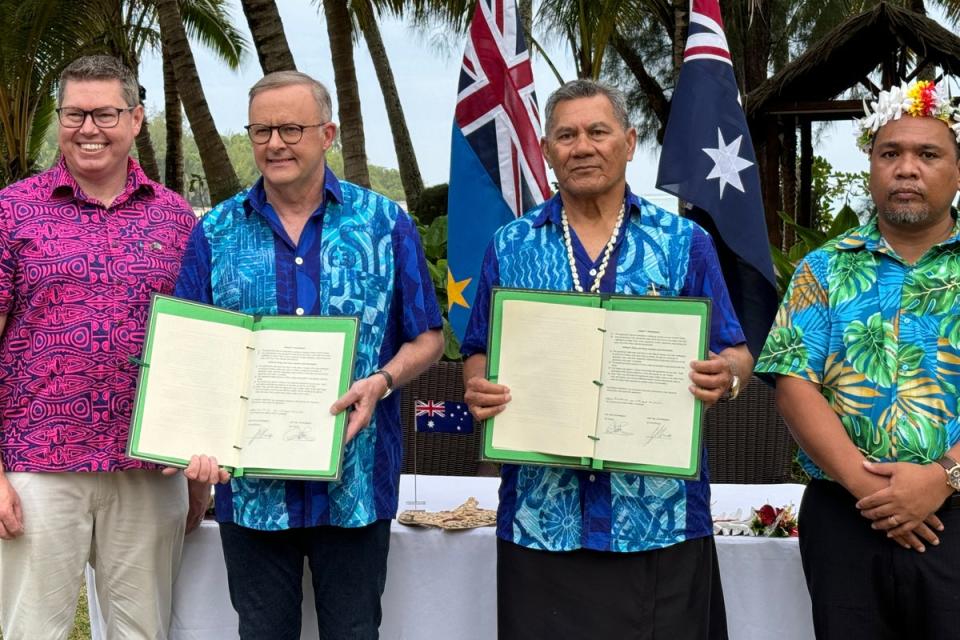 Australian Prime Minister Anthony Albanese and Tuvalu Prime Minister Kausea Natano display a compact between the two nations at the Pacific Resort, Rarotonga, the Cook Island (EPA)