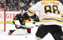 Vancouver Canucks' goalie Arturs Silovs (31) stops the shot of Boston Bruins' David Pastrnak (88) during the second period of an NHL hockey game, Saturday, Feb. 25, 2023 in Vancouver, British Columbia. (Rich Lam/The Canadian Press via AP)