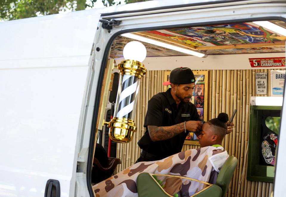 Justin Bowen, of Fresh Barber Zone, gives a cut to Malachi Triplett, 11, of Vero Beach, during the Juneteenth Celebration of Freedom festival Wednesday, June 19, 2024, at River Walk Center, 600 N. Indian River Dr., in Fort Pierce. The event featured live music, a kid zone, vendors and food. Juneteenth is an annual celebration that commemorates the ending of slavery in the United States. President Lincoln signed the Emancipation Proclamation on Jan. 1, 1863 to free all slaves, news of the emancipation did not reach enslaved people in Florida until May 20, 1865 and Texas until June 19, 1865.