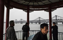 <p>The “Friendship Bridge” is seen in the background as Chinese men take part in morning exercises on the Yalu river in the border city of Dandong, Liaoning province, northern China across from the city of Sinuiju, North Korea on May 23, 2017 in Dandong, China. (Photo: Kevin Frayer/Getty Images) </p>