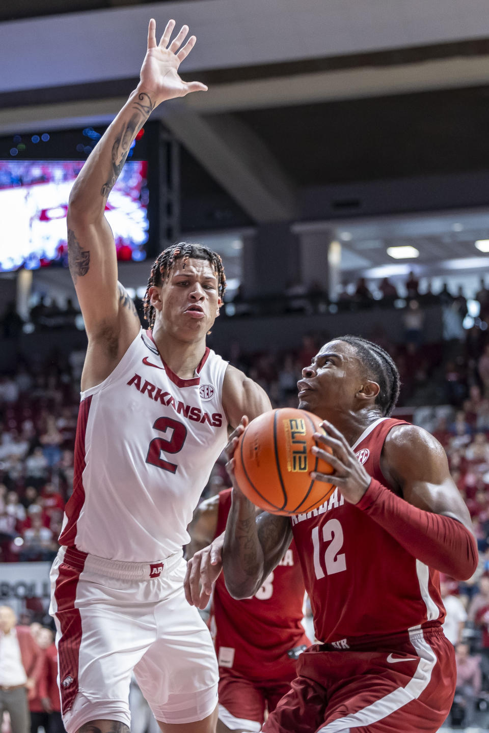 Alabama guard Latrell Wrightsell Jr. (12) works inside against Arkansas forward Trevon Brazile (2) during the first half of an NCAA college basketball game, Saturday, March 9, 2024, in Tuscaloosa, Ala. (AP Photo/Vasha Hunt)