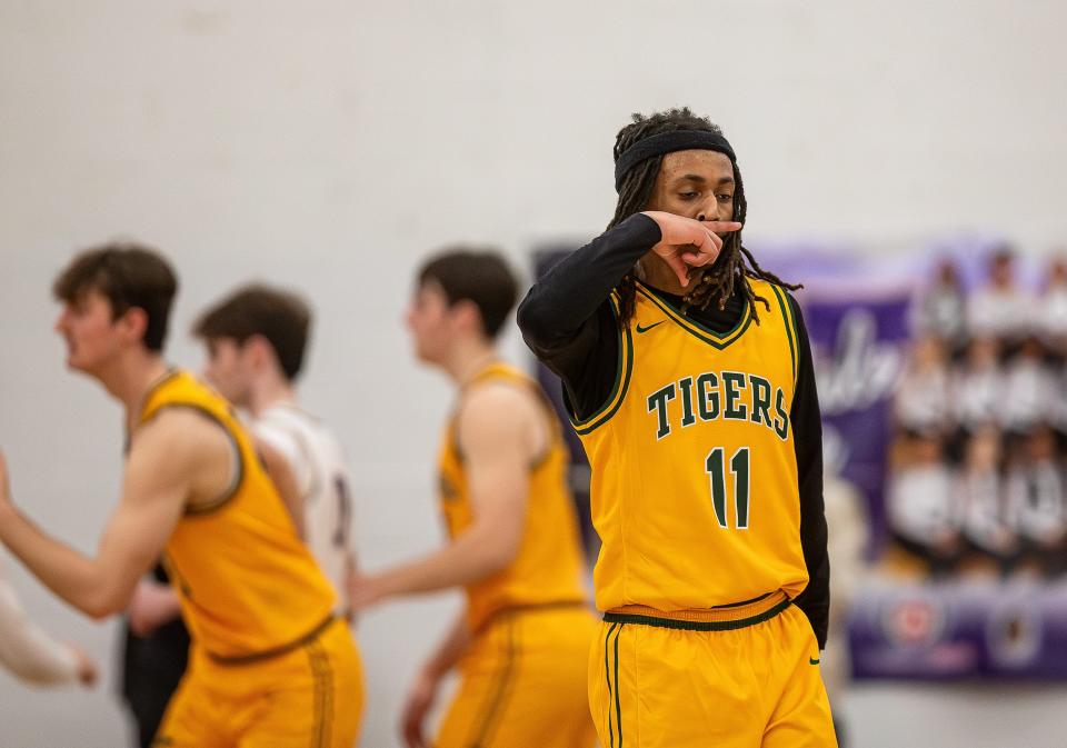 Xavier's Chance Dillingham (11) celebrated after draining a three-pointer as the Men's Bulldogs took on the St. X Tigers on Monday night at Male High School.  Saint Xavier defeated Male 80-77.  February 12, 2024