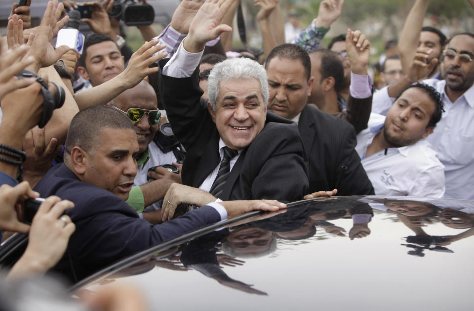 Presidential hopeful leftist politician Hamdeen Sabahi, who finished a strong third in the first round of the last presidential election, in June 2012, greets his supporters outside the election commission office in Cairo, Egypt, Saturday, April 19, 2014. Sabahi submitted required signatures to the election commission as the final formal step to run in next month’s presidential election. The presidential ballot will be followed by a parliamentary election later this year. (AP Photo/Amr Nabil)