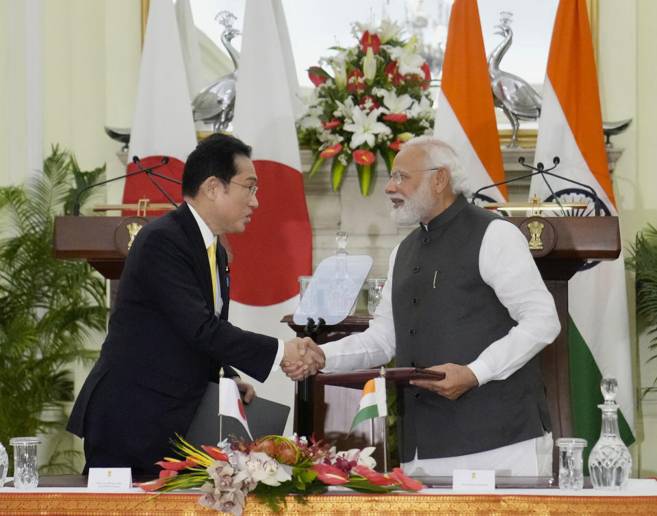 Indian Prime Minister Narendra Modi shakes hand with his Japanese counterpart Fumio Kishida during a signing of agreements in New Delhi, Saturday, March 19, 2022. Kishida is meeting with Modi to strengthen their partnership in the Indo-Pacific and beyond in view of China’s growing footprint in the region, an Indian official said Thursday. (AP Photo/Manish Swarup)