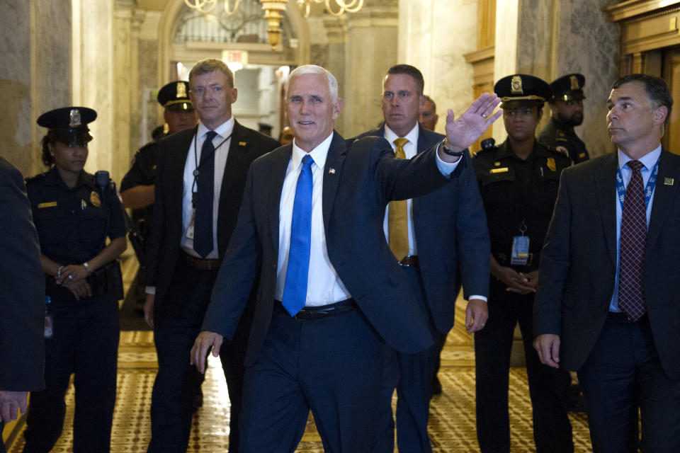 Vice President Mike Pence, center, heads to the Senate as the Republican majority in Congress remains stymied by their inability to fulfill their political promise to repeal and replace "Obamacare" because of opposition and wavering within the GOP ranks, on Capitol Hill in Washington, Thursday, July 27, 2017. (AP Photo/Cliff Owen)