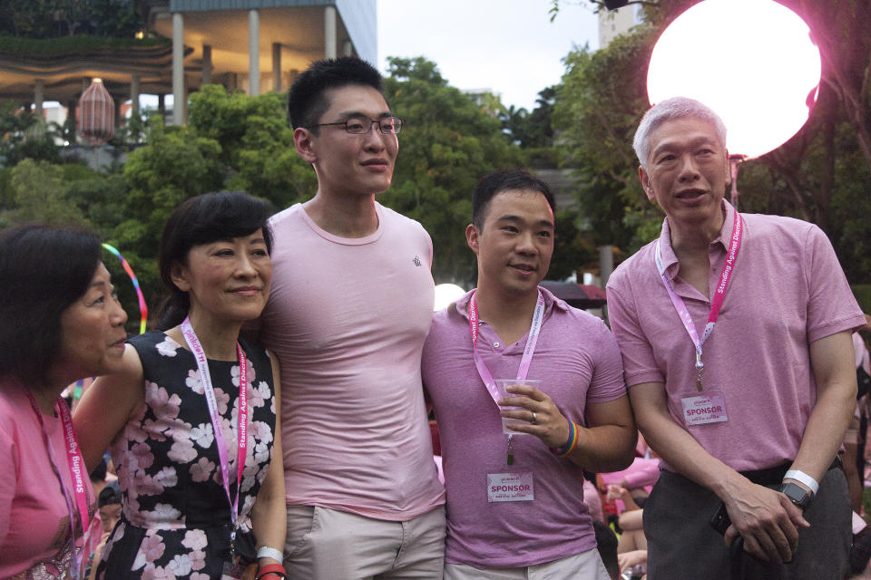 SINGAPORE, SINGAPORE - JUNE 29: Lee Hsien Yang, the brother of Singapore's Prime Minister Lee Hsien Loong, together with his wife and second son Li Huanwu and his husband Heng Yirui attend the Pink Dot event held at the Speaker's Corner in Hong Lim Park on June 29, 2019 in Singapore. (Photo by Ore Huiying/Getty Images)