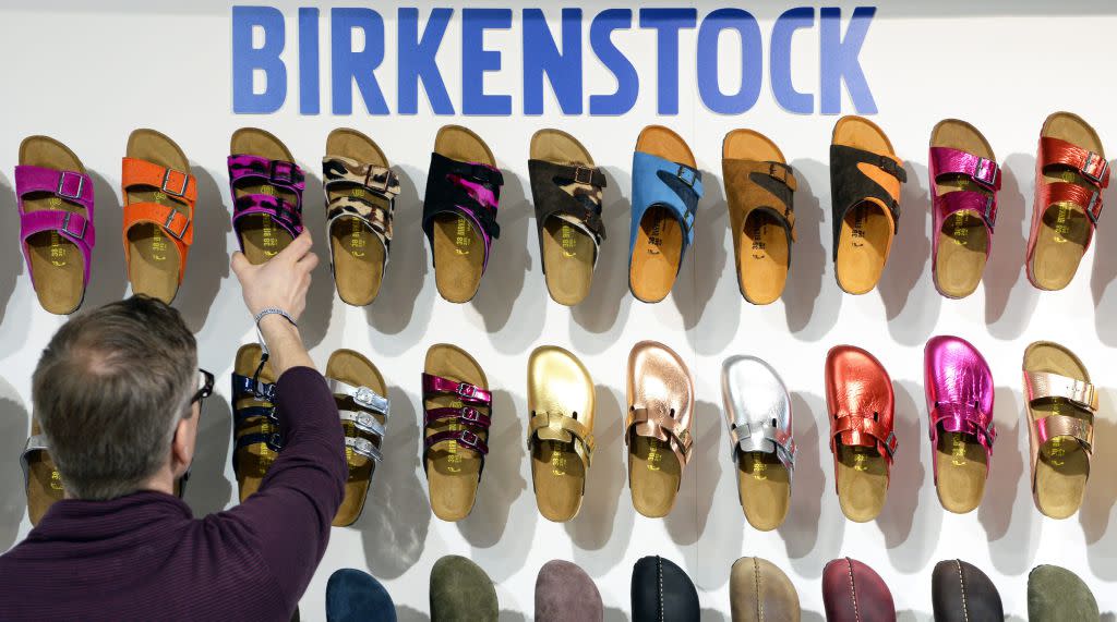 A employee arranges shoes of German label Birkenstock during the fashion fair 'Bread & Butter' in the former Tempelhof airport in Berlin, Germany, 14 January 2014. 'B&B' takes place during the Berlin Fashion Week that presents the Autumn/Winter 2014/2015 collections and runs from 11 to 14 January. EPA/SOEREN STACHE
